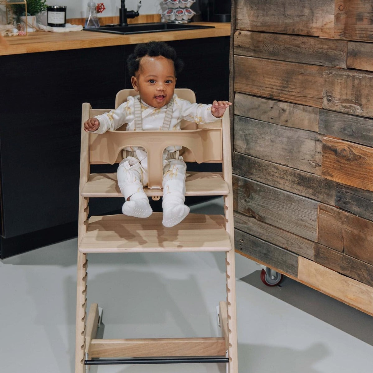 Stokke Tripp Trapp Highchair in NAtural lifestyle of baby in seat with babyset