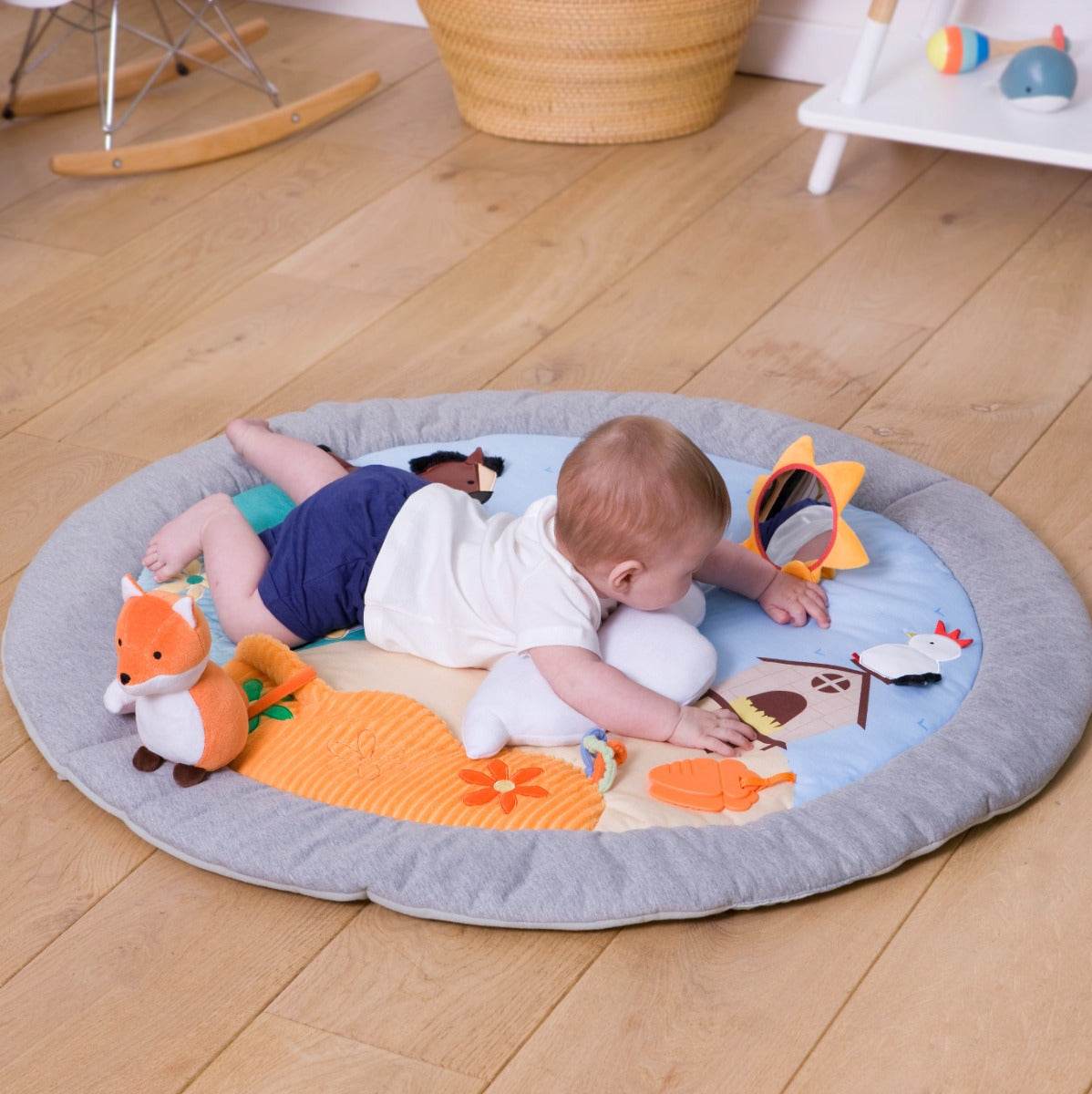 Baby lying on Little Big Friends Activity Playmat farm theme