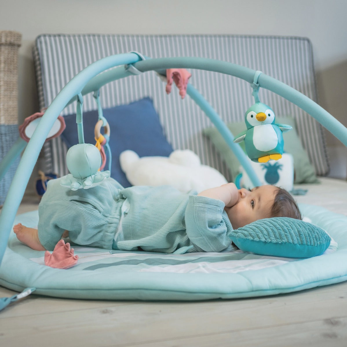 Baby palying under Little Big Friends Activity Mat with Arch in ocean