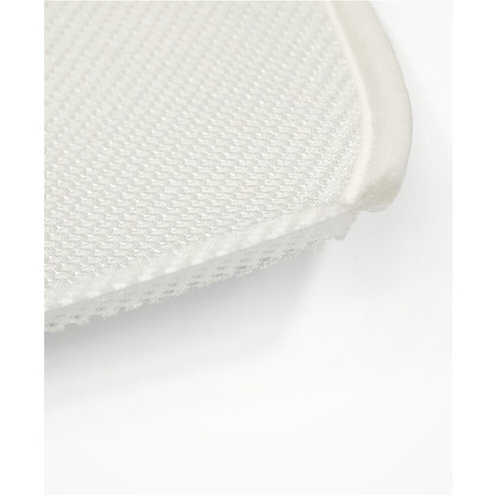 Close-up of a white woven chair seat on a light gray background