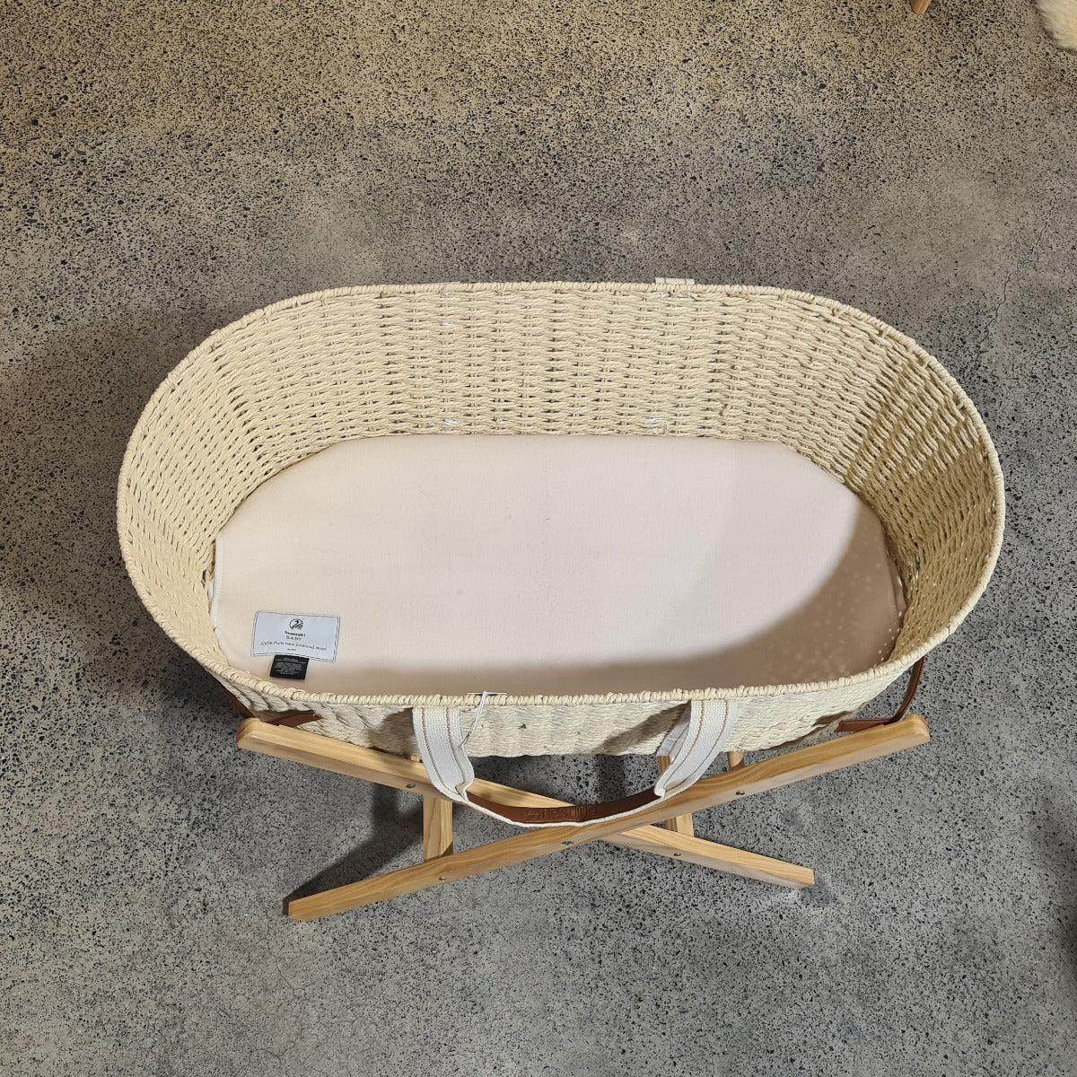 Dri-cot wool mattress protector in a Moses basket, bassinet