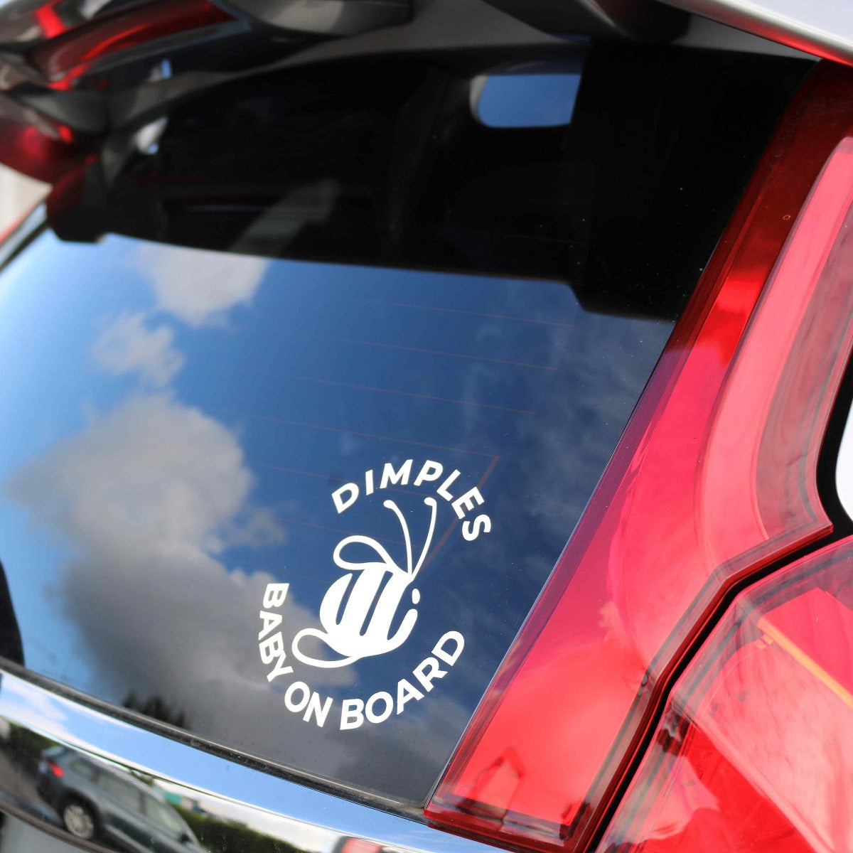 Dimples by Jane Anne Baby on Board Sticker on red car