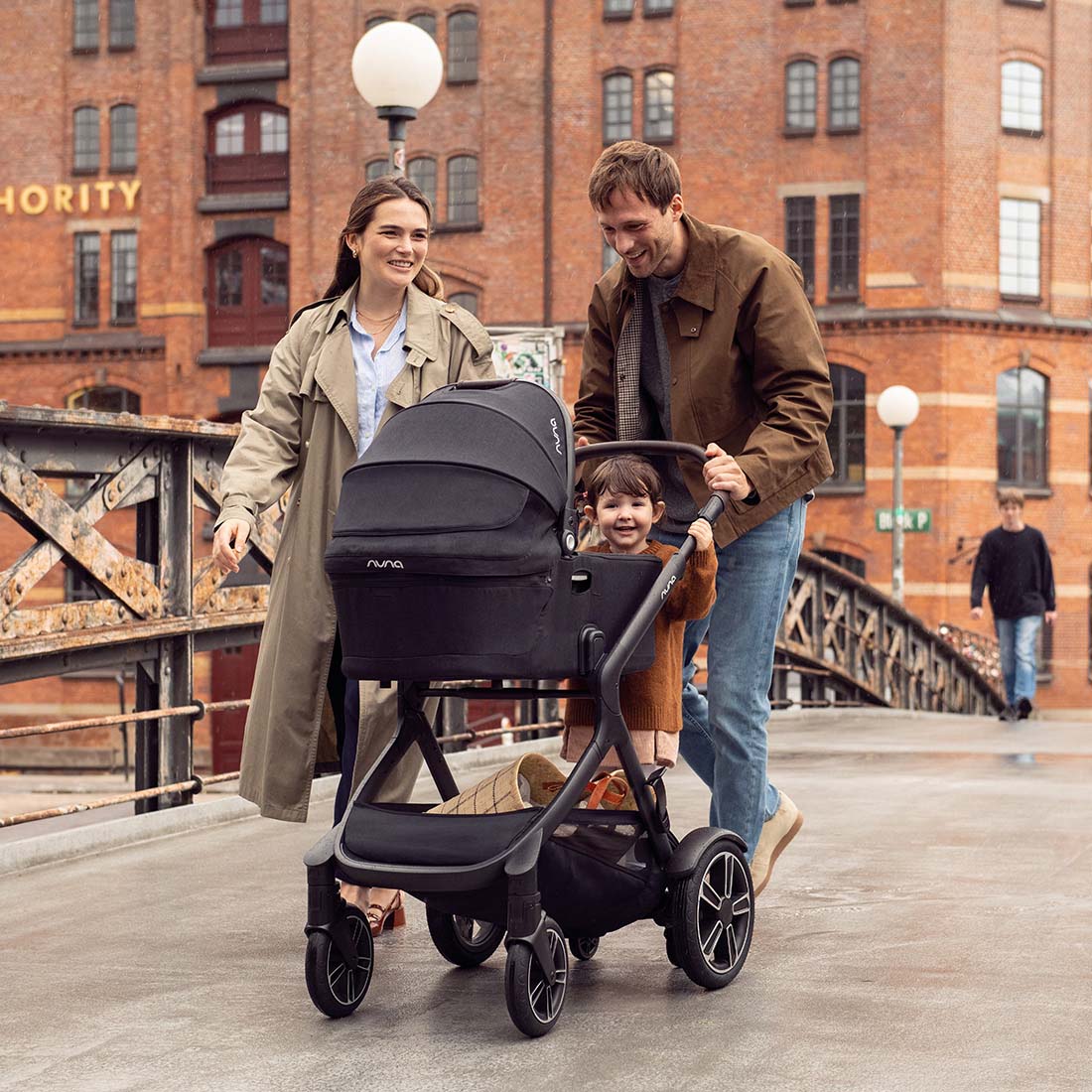 parents and baby boy pushing Nuna Demi Carry Cot with stroller