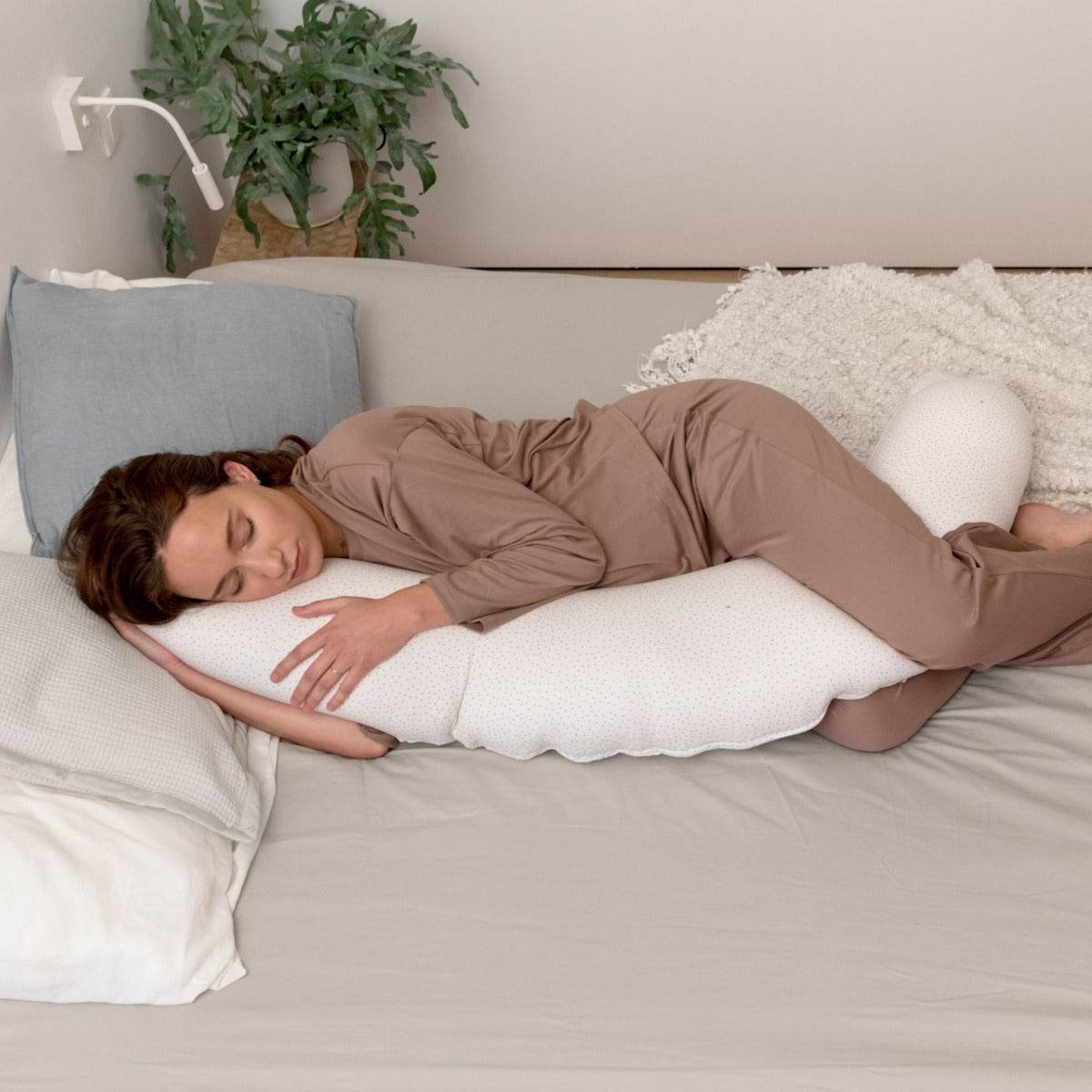 Women sleeping peacefully with Doo Moo Silver Dots Pregnancy Pillow