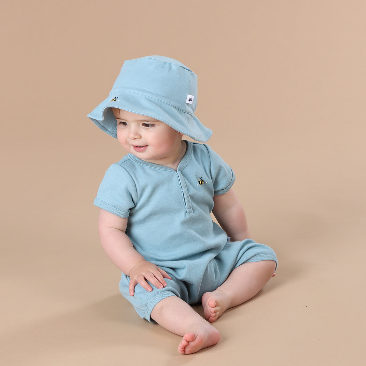 Baby girl wearing Ocean Cotton romper and ocean sunhat