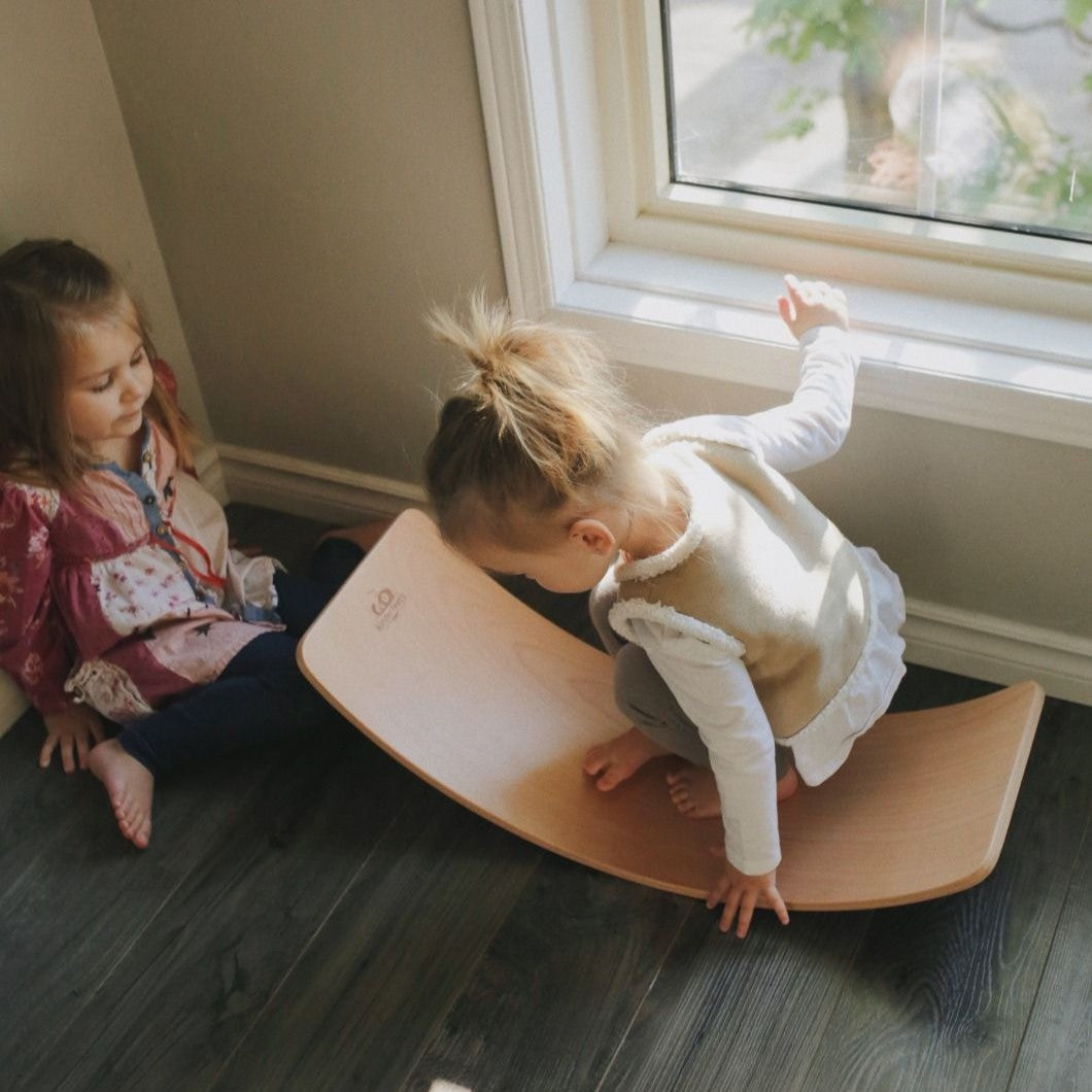 little girl sitting on Kinderfeets Lite Board