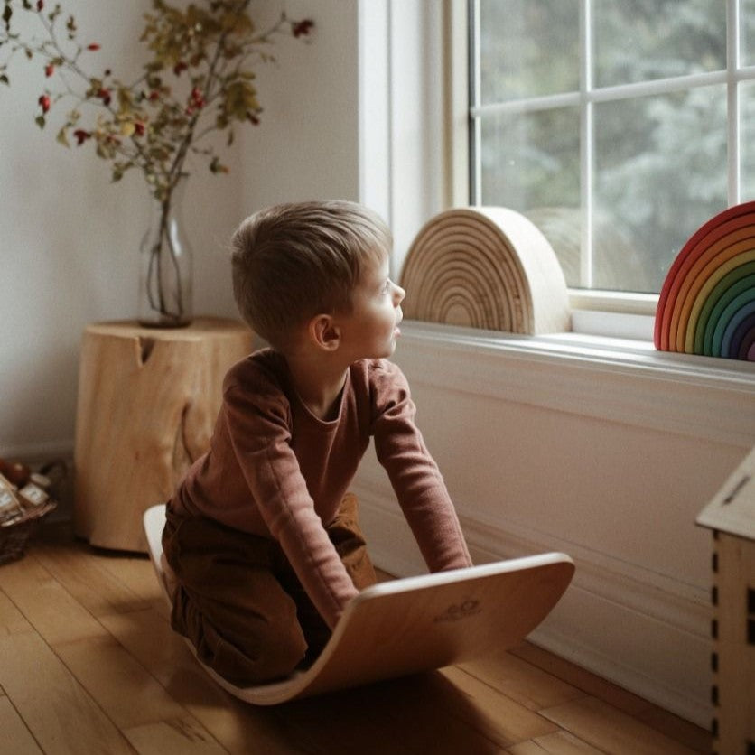 Toddler kneeling on Kinderfeets Lite Board