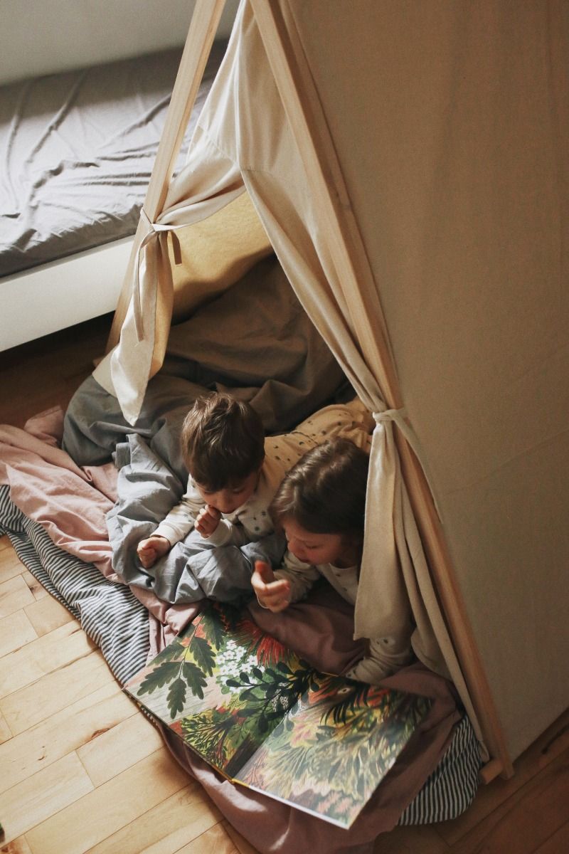 Two children laying inside Kinderfeets Kid Tent