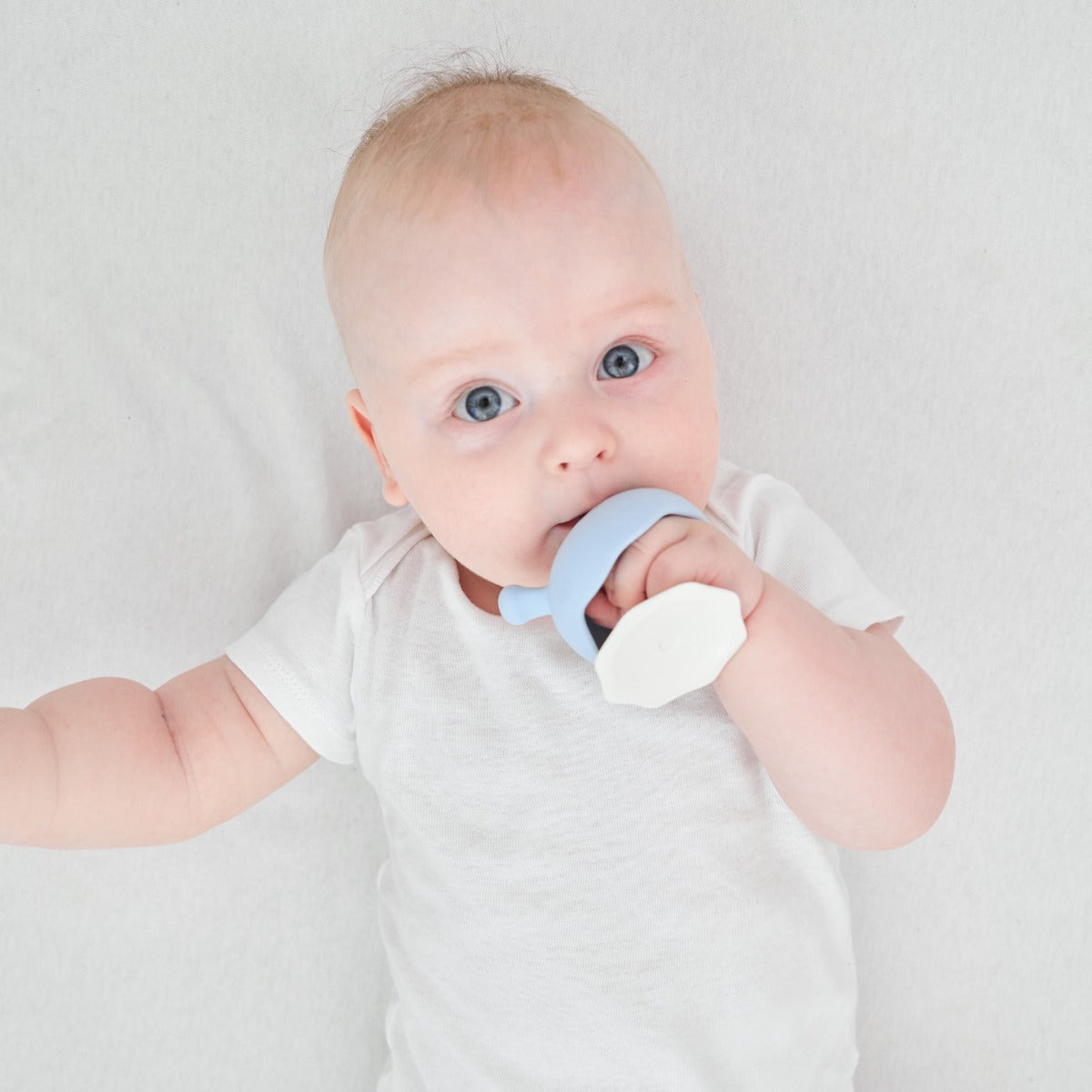 Baby playing with Mombella iron green mushroom teether