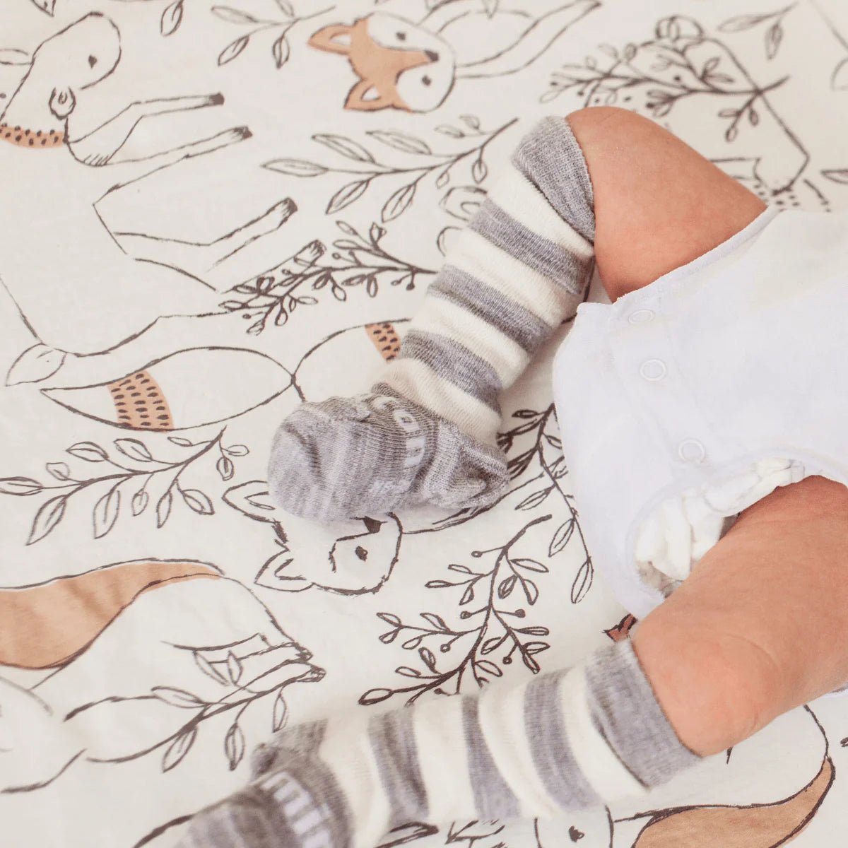 Baby wearing White Grey Stripes Merino Wool Kneehigh Socks for Baby from Lamington