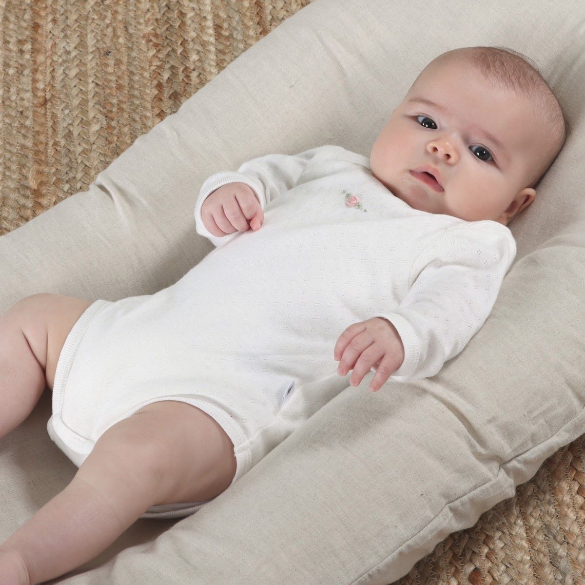 Dimples Cotton Longsleeve Bodysuit in white rose on baby