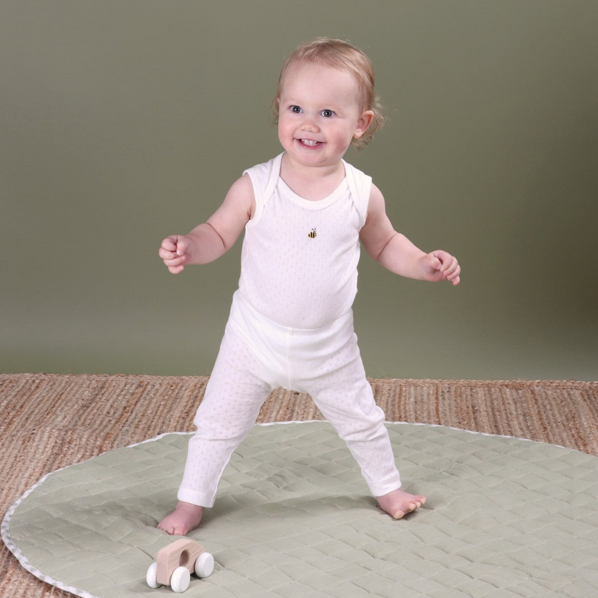 Dimples Cotton SLeeveless Bodysuit in white bee on baby