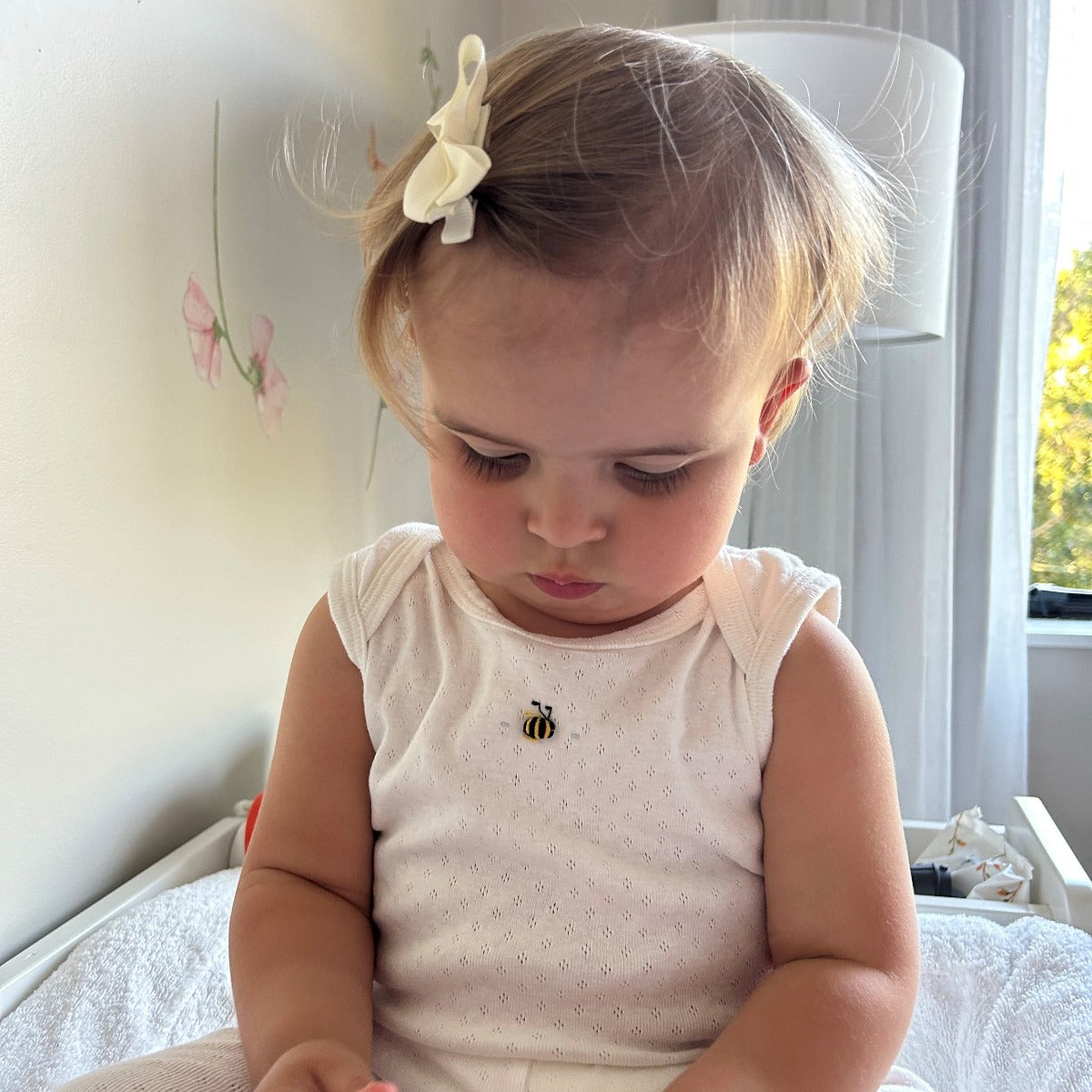 Dimples Cotton SLeeveless Bodysuit in white bee on baby