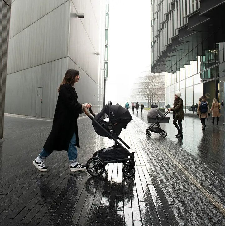 Women pushingPipa Urbn EU Version in Caviar by Nuna on stroller