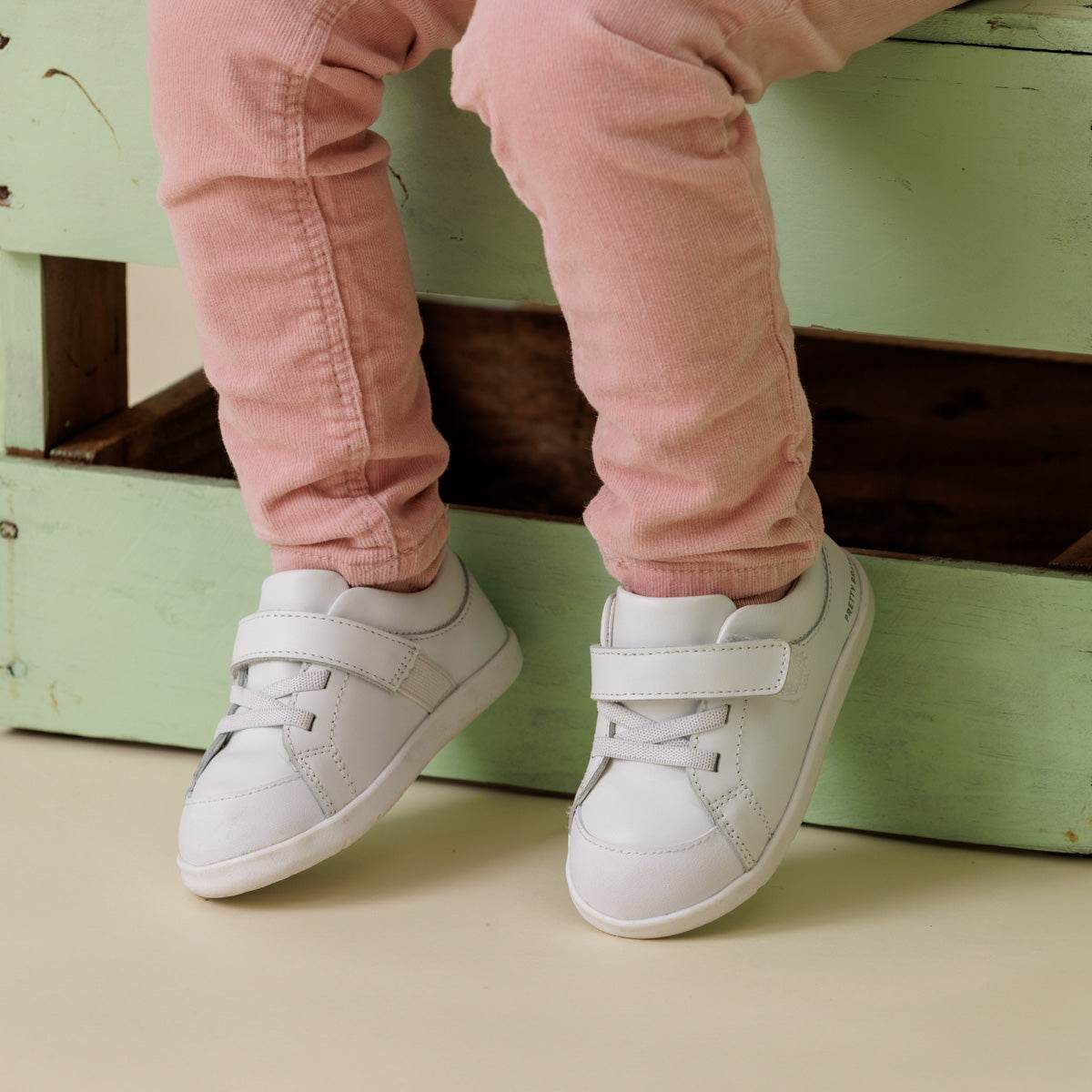 Baby wearing 1st walker white shoes