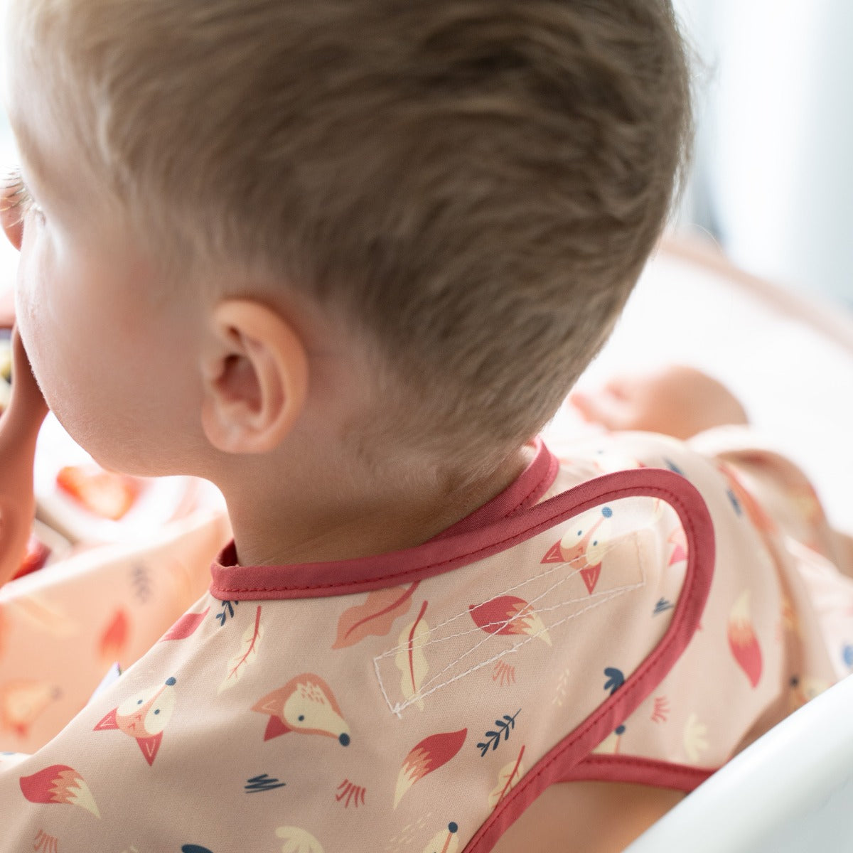 Baby eating wearing overall long sleeve bib with fox print well crow