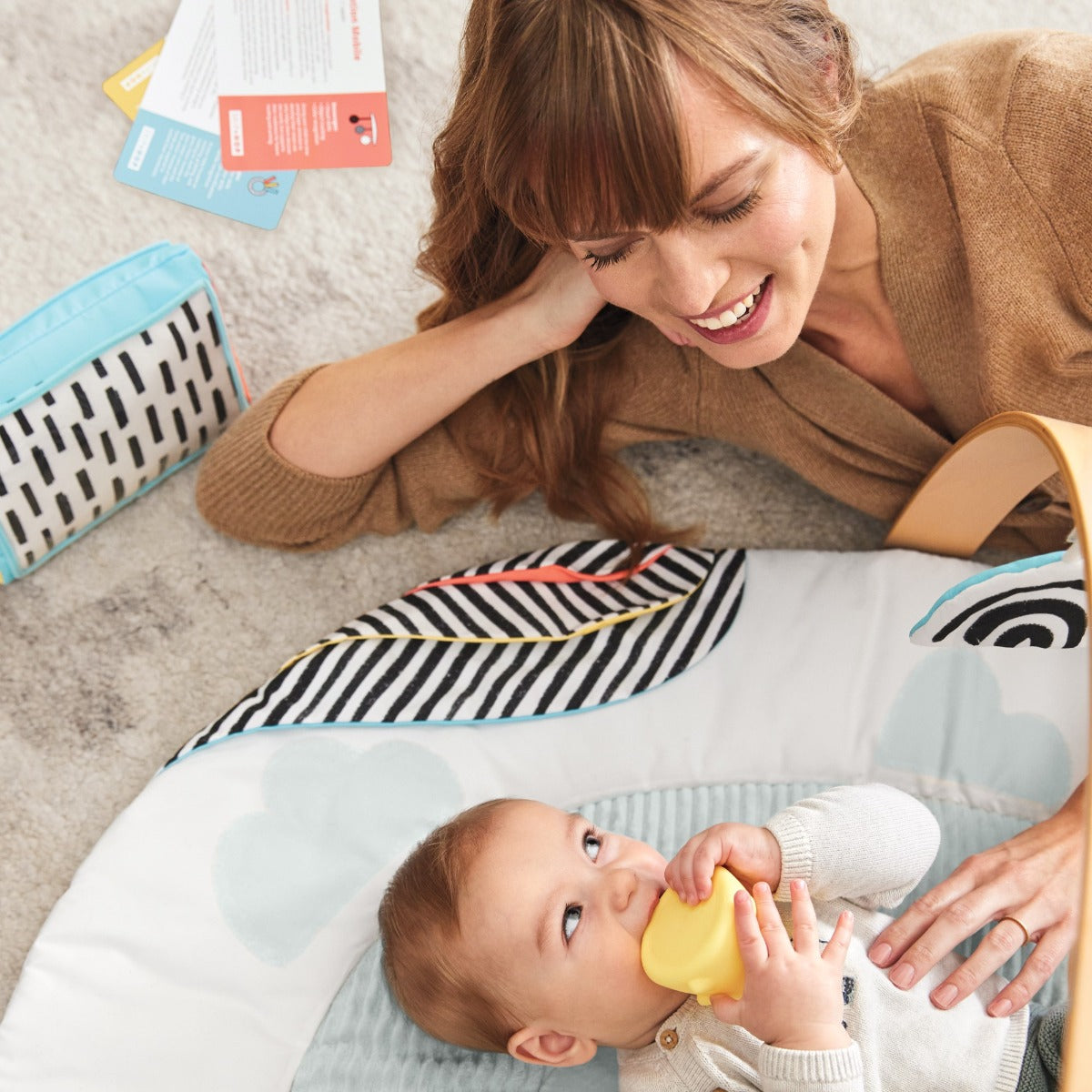 Mom and baby playing on Deluxe Activity Gym - Discoverosity Montessorifrom Skip Hop
