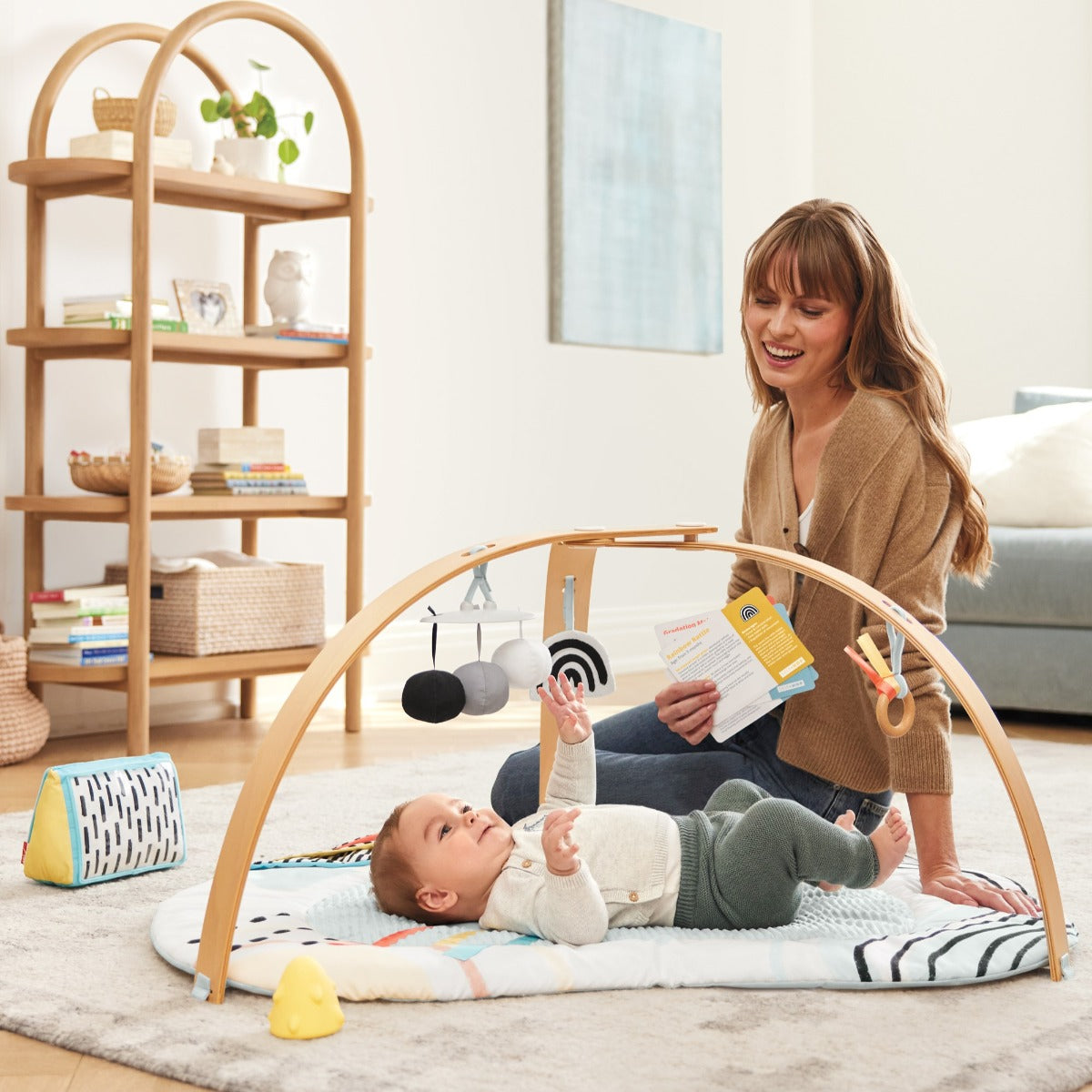 Mother watching Baby boy playing with Deluxe Activity Gym - Discoverosity Montessorifrom Skip Hop