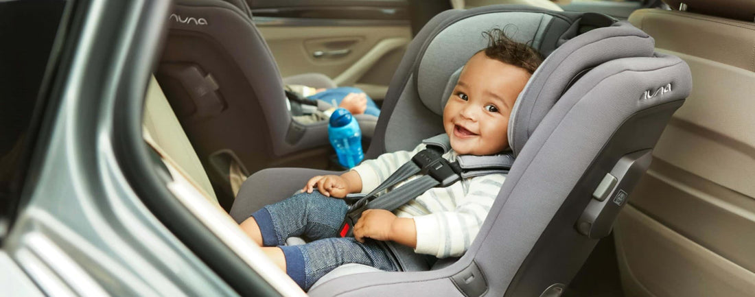 Baby sitting in a car seat similing