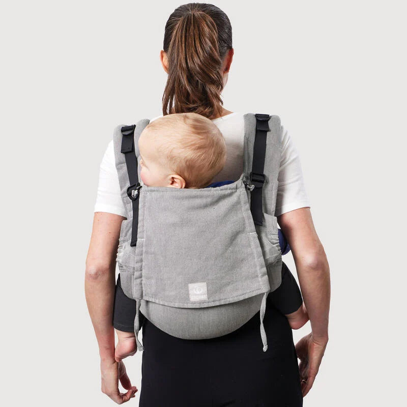 Mother carrying baby in Stokke Limas Carrier plus in Grey back carrying.