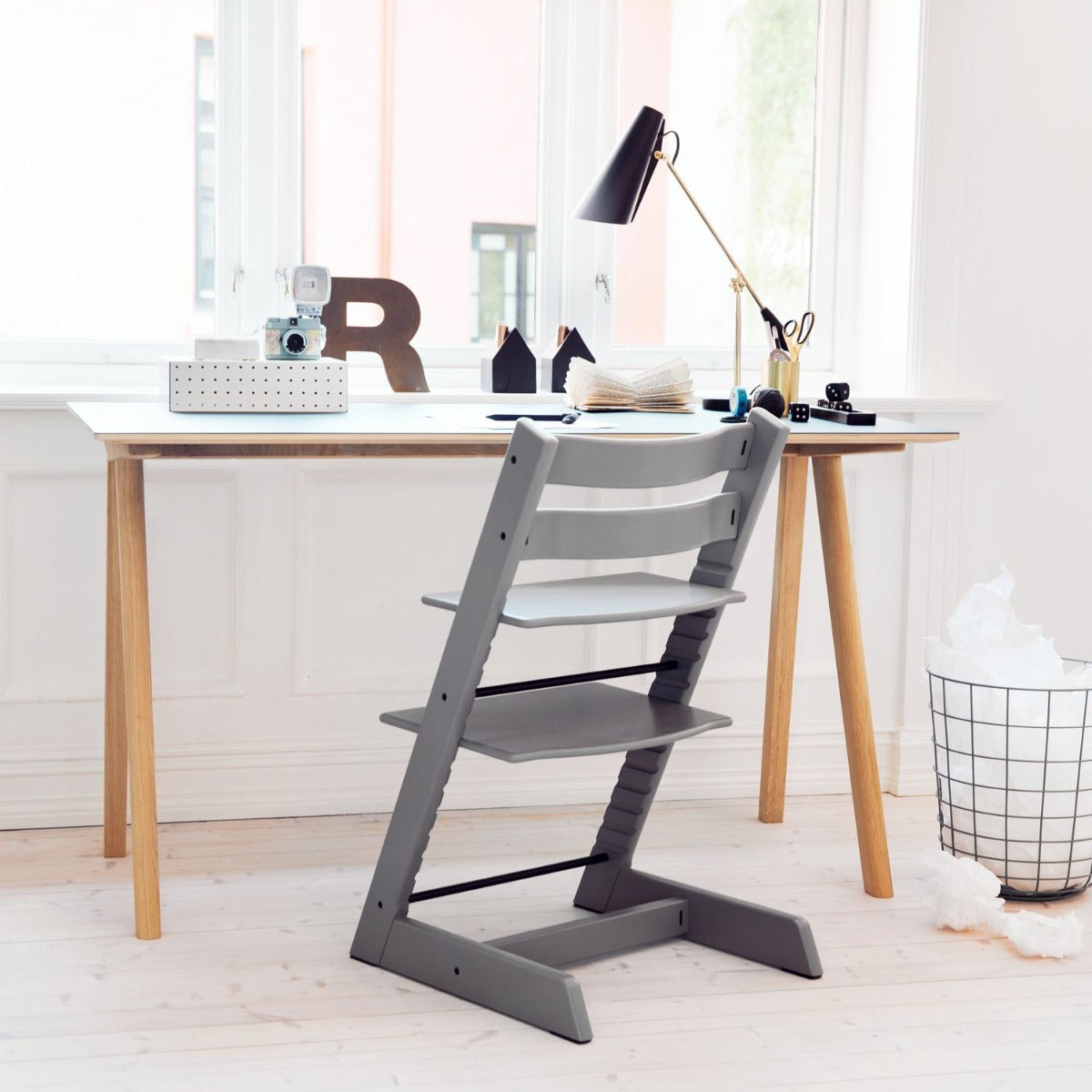 Stokke tripp trapp highchair in Storm Grey in lifestyle setting as a desk chair