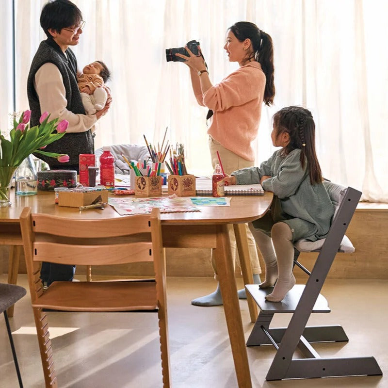 Family in dining room using Stokke Tripp Trapp Highchair