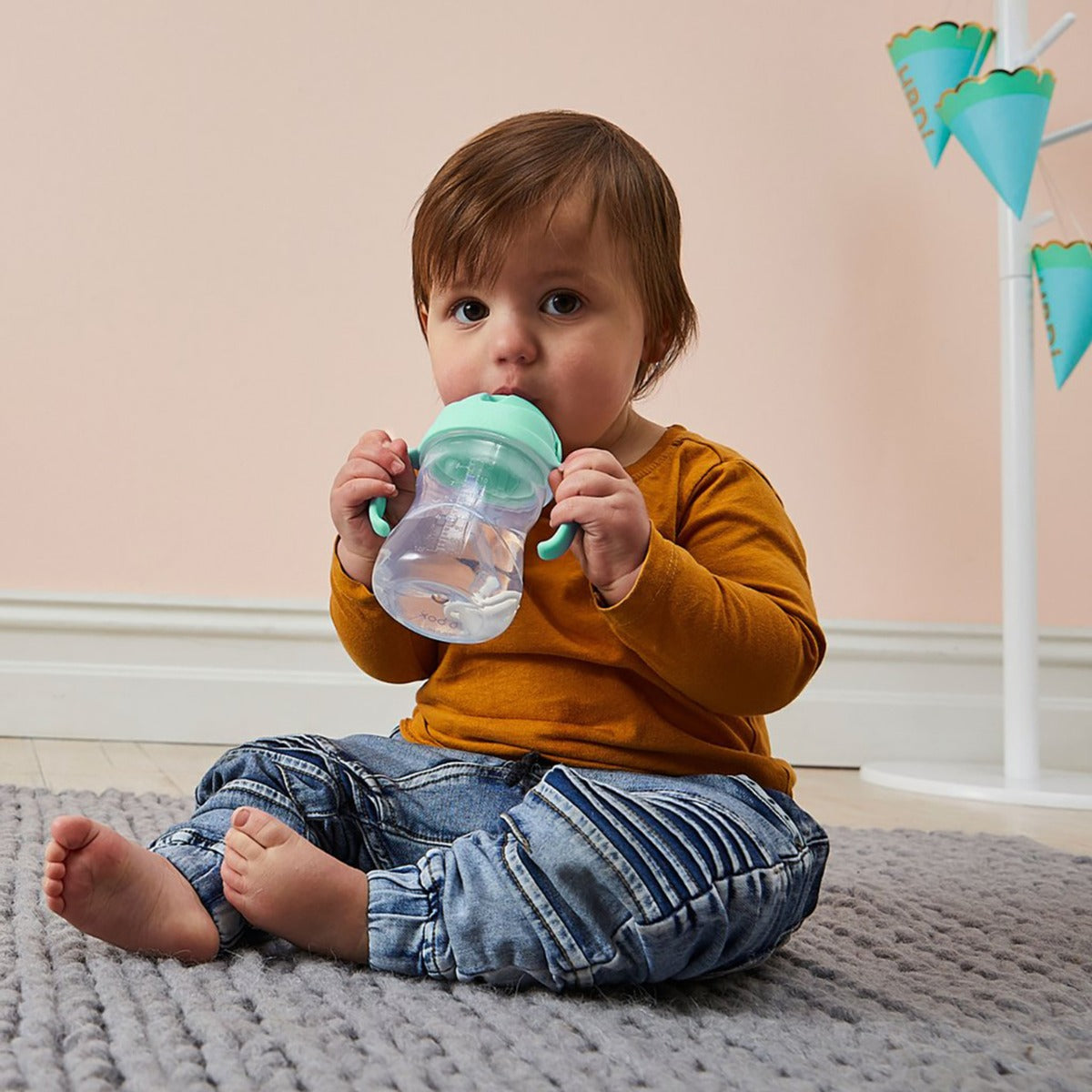 Baby boy drinking water from B.Box pistachio sippy cup