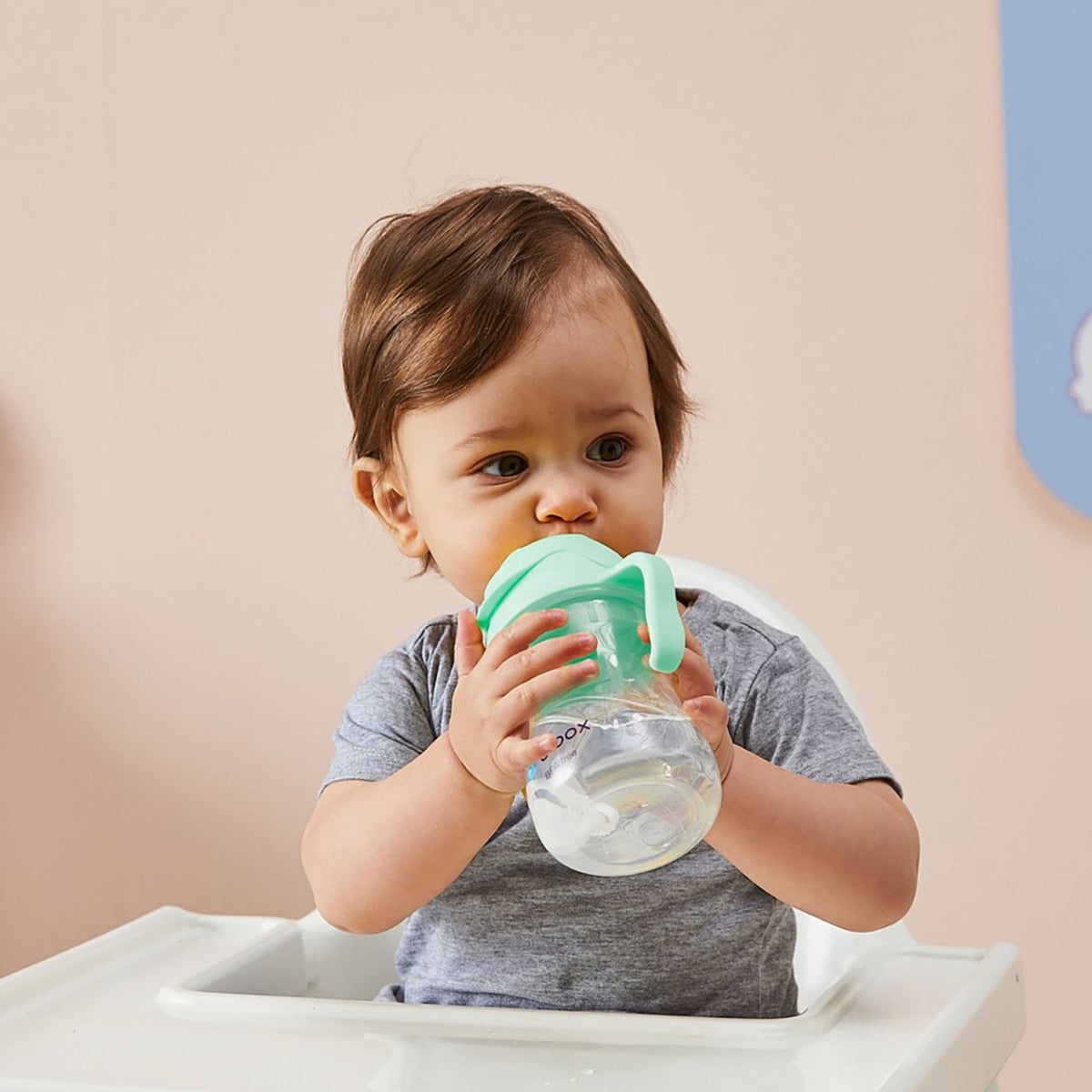 Baby boy drinking water from B.Box pistachio sippy cup