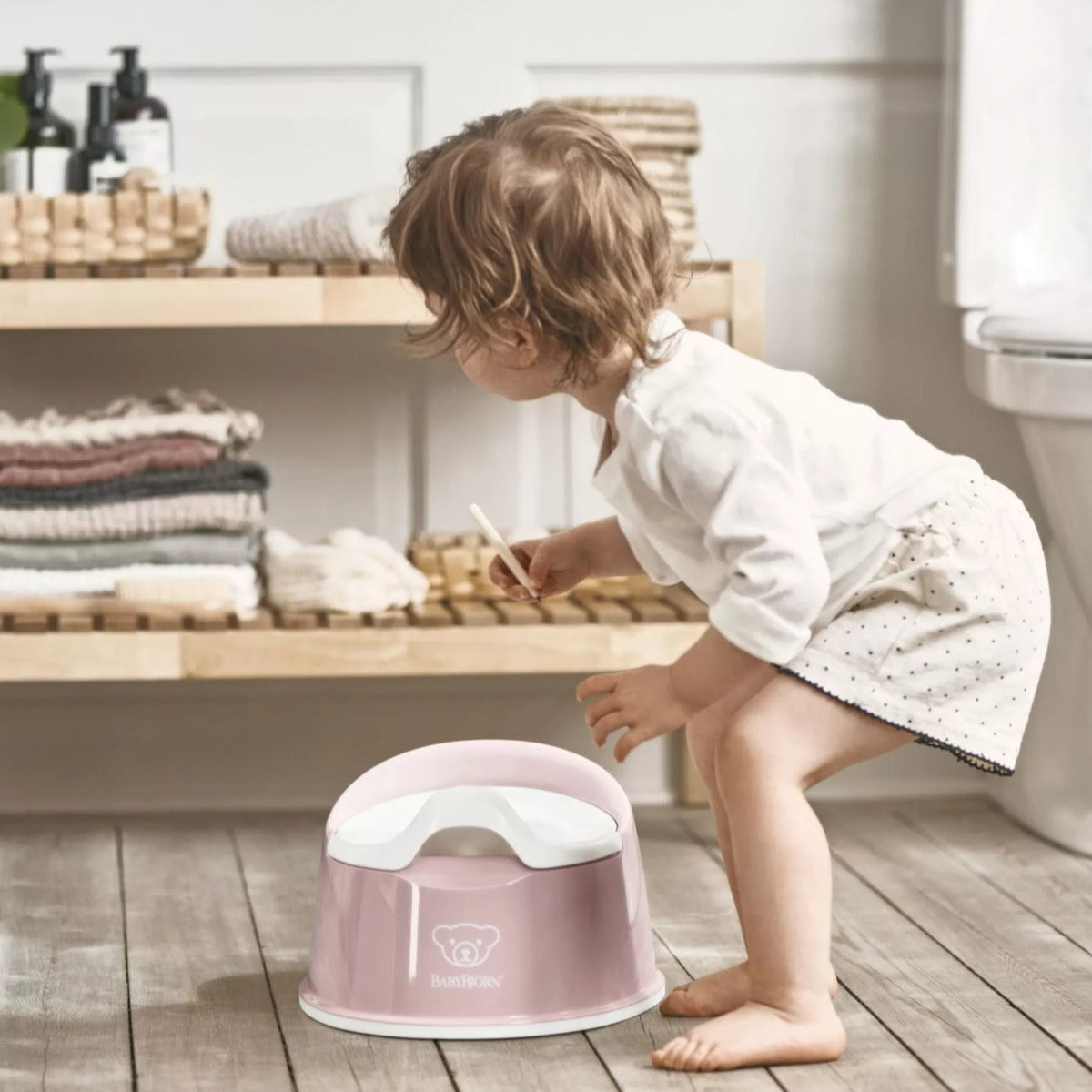 Baby with Babybjorn Smart Potty in pink