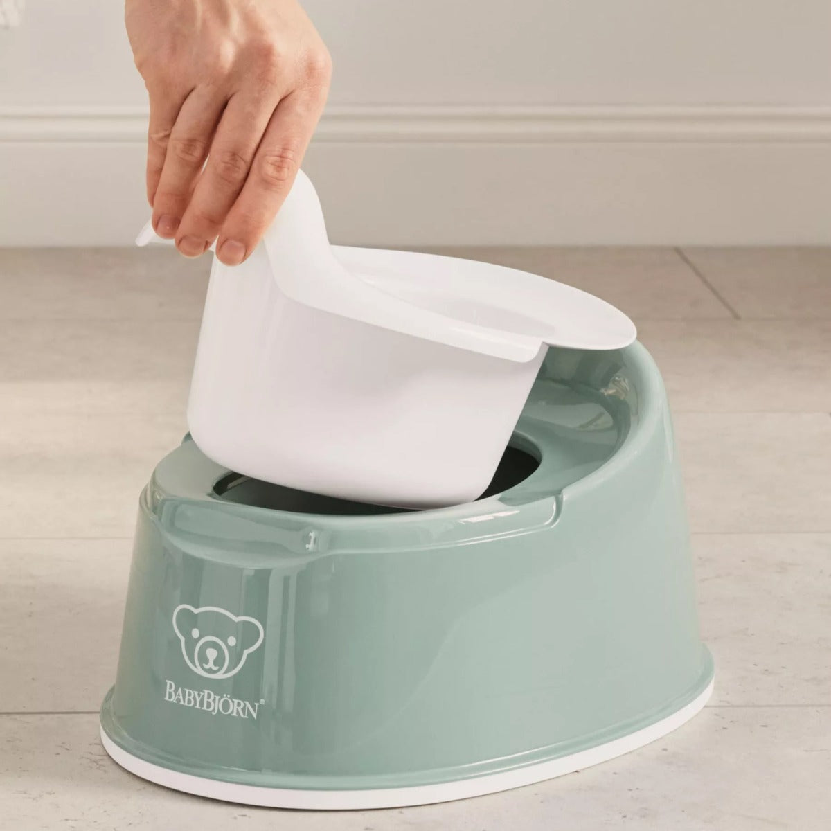 Babybjorn Smart Potty in green with lifted seat