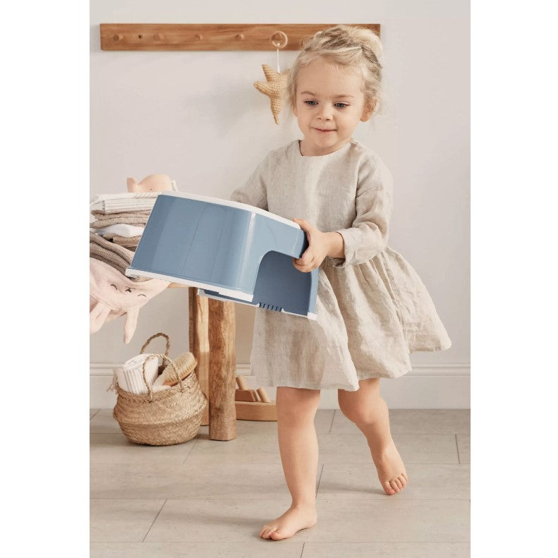 Girl lifting Babybjorn Blue Step Stool