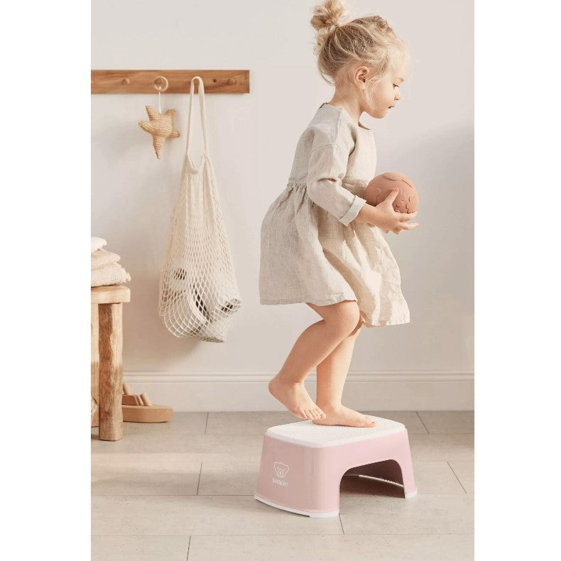 Baby girl standing on Babybjorn Powder Pink Step Stool