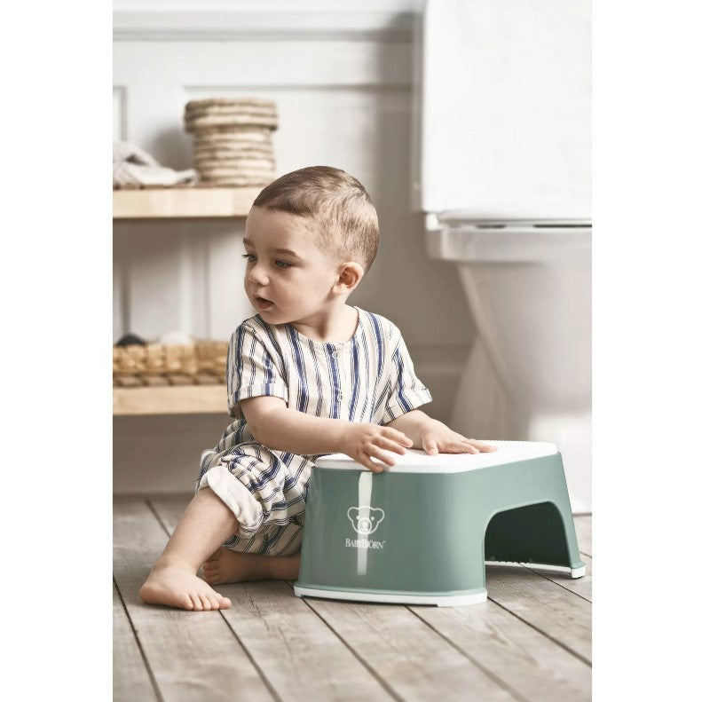 Baby with a Babybjorn Deep green Step Stool in bathroom