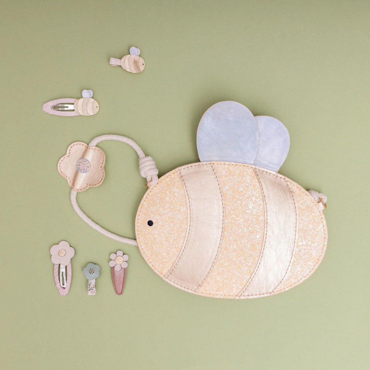 Bee shaped bag with glitter attached to strap with mini hair clips