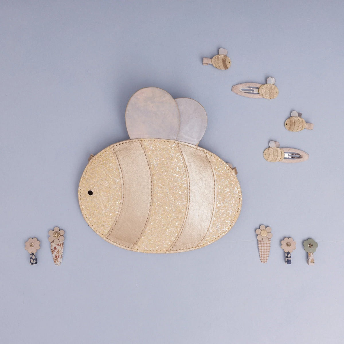 Bee shaped bag with glitter attached to strap with mini hair clips