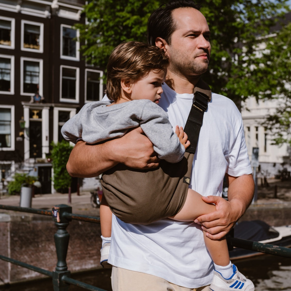 Father holding son with Wildride Toddler Carrier in Coffee Colour