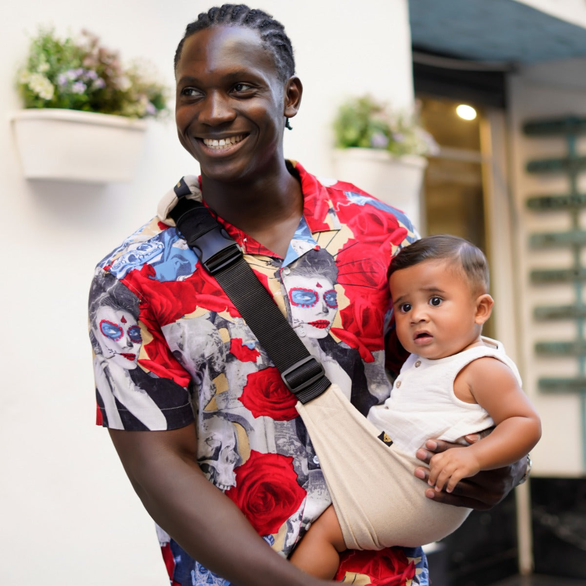 Father holding baby in Wildride Toddler Carrier in Sand at restaurant