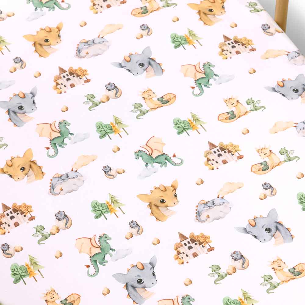 Snuggle Hunny organic cotton cot sheet in dragon print in cot