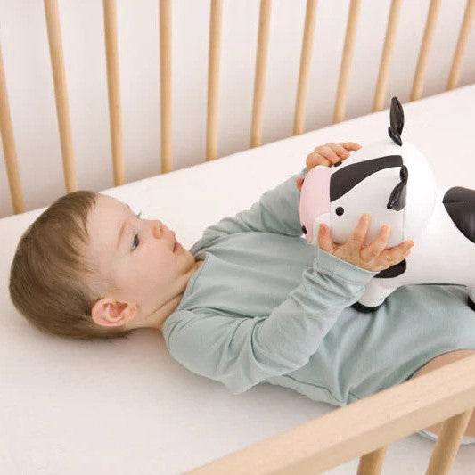 Baby holding Emma the Cow 