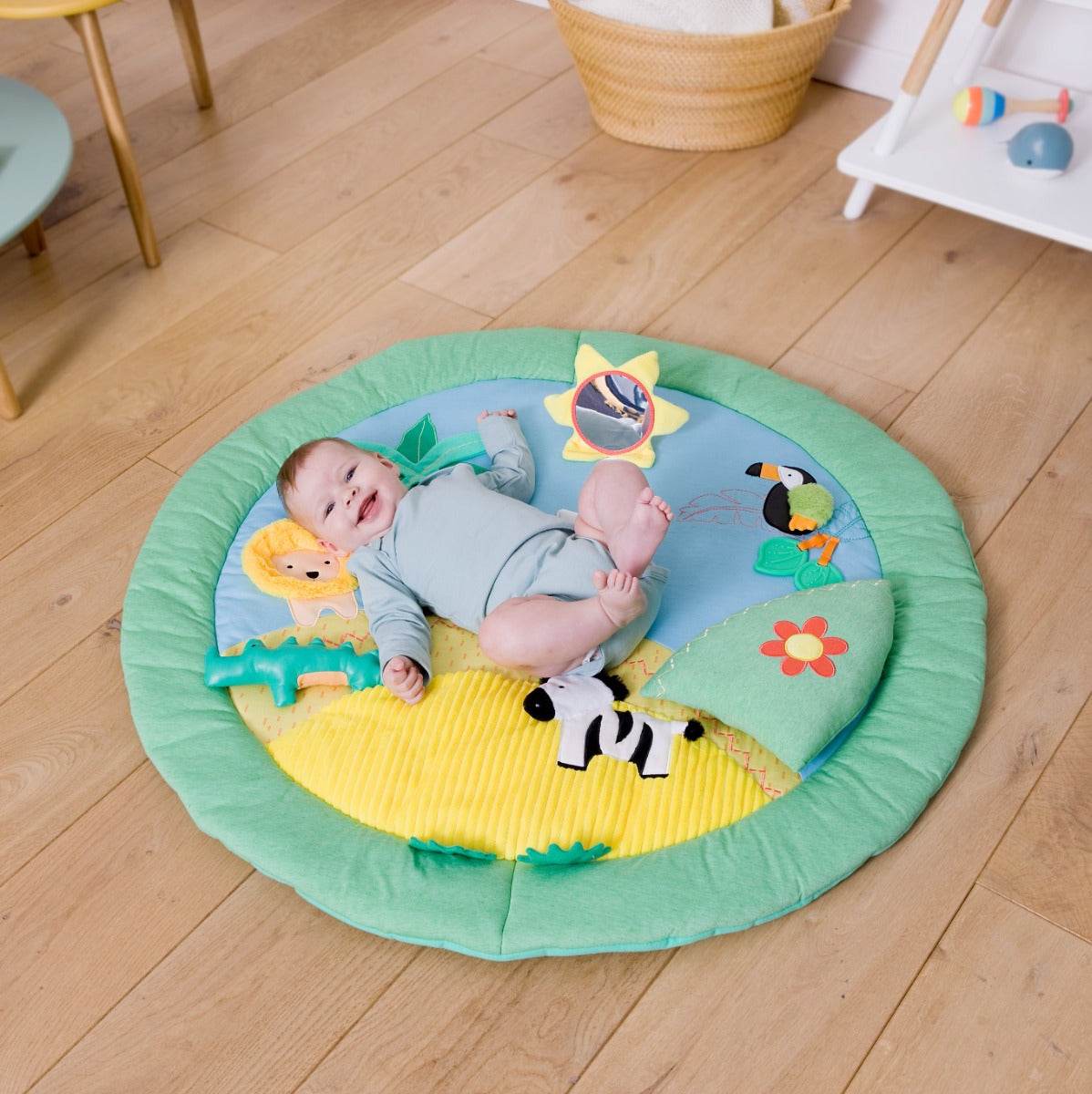 Baby lying on a Jungle theme Little Big Friends Activity Playmat