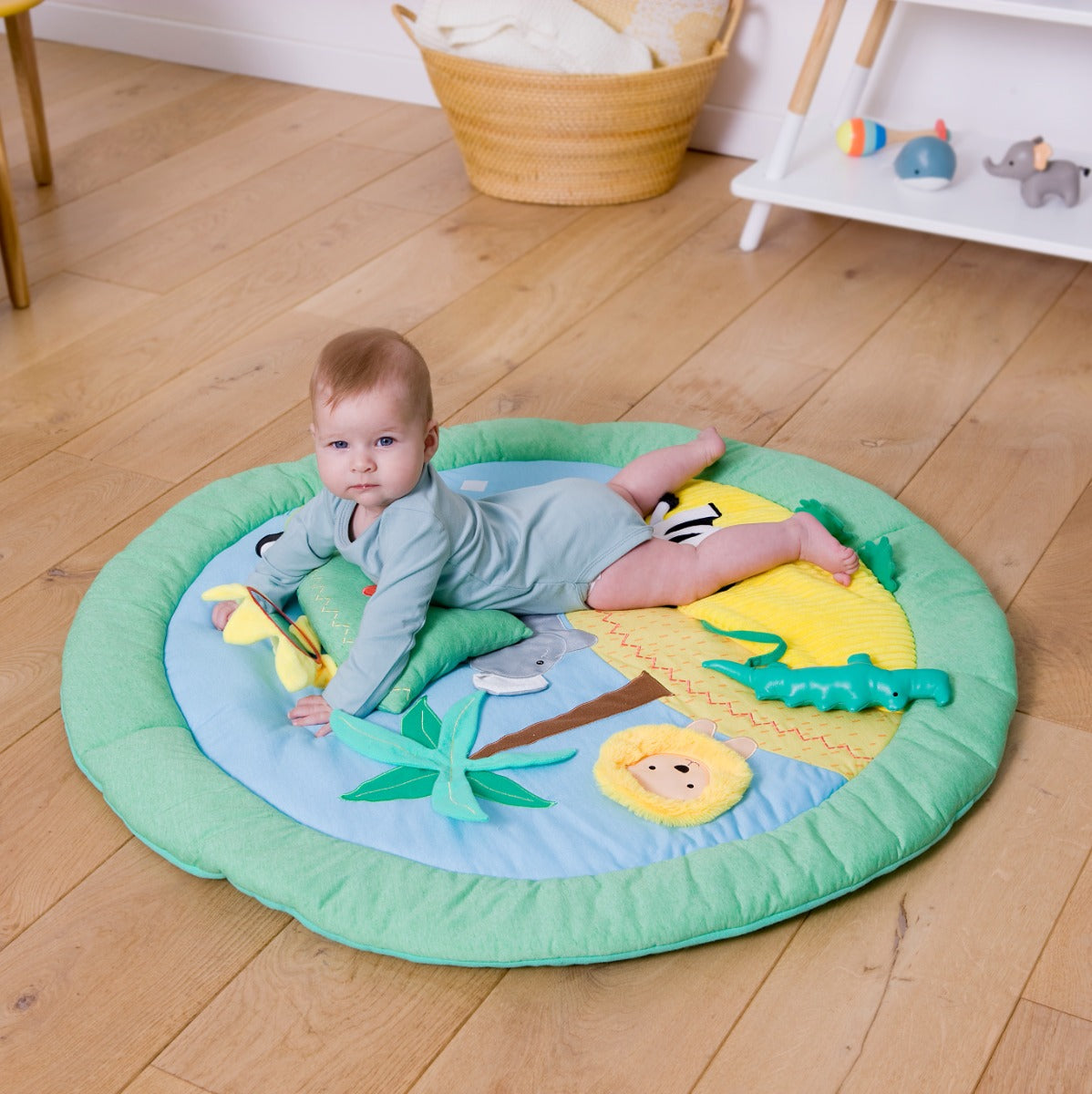 Baby lying on a Jungle theme Little Big Friends Activity Playmat