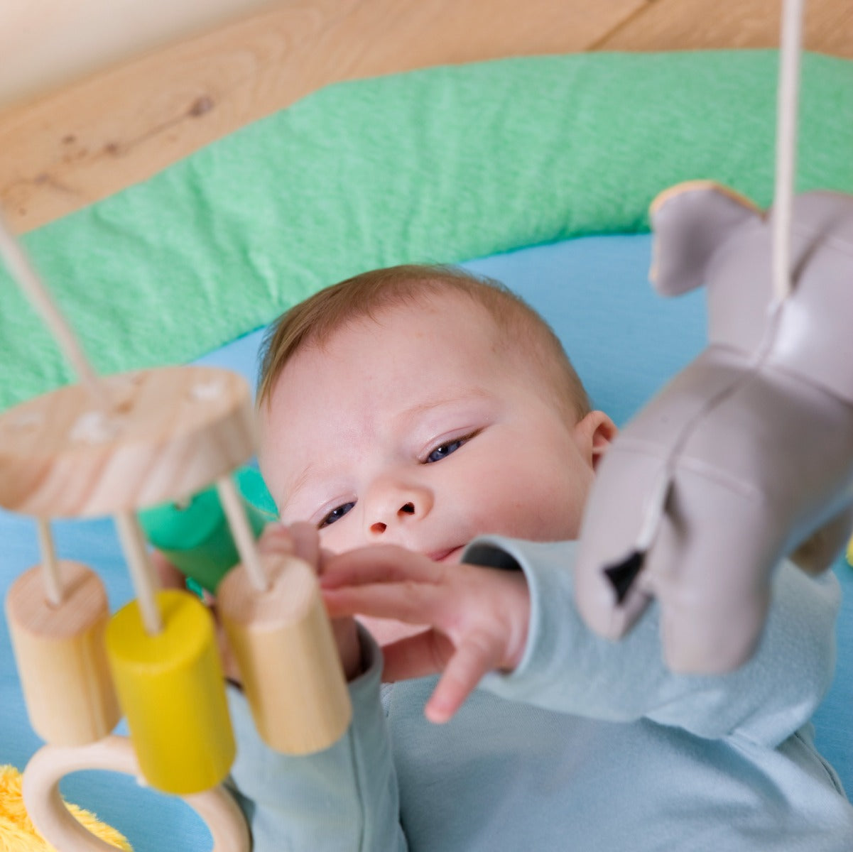 Baby lying on a Jungle theme Little Big Friends Activity Playmat