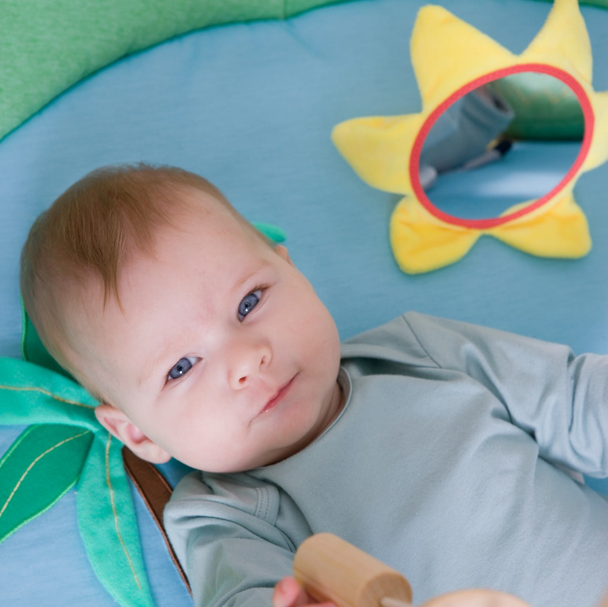 Baby lying on a Jungle theme Little Big Friends Activity Playmat