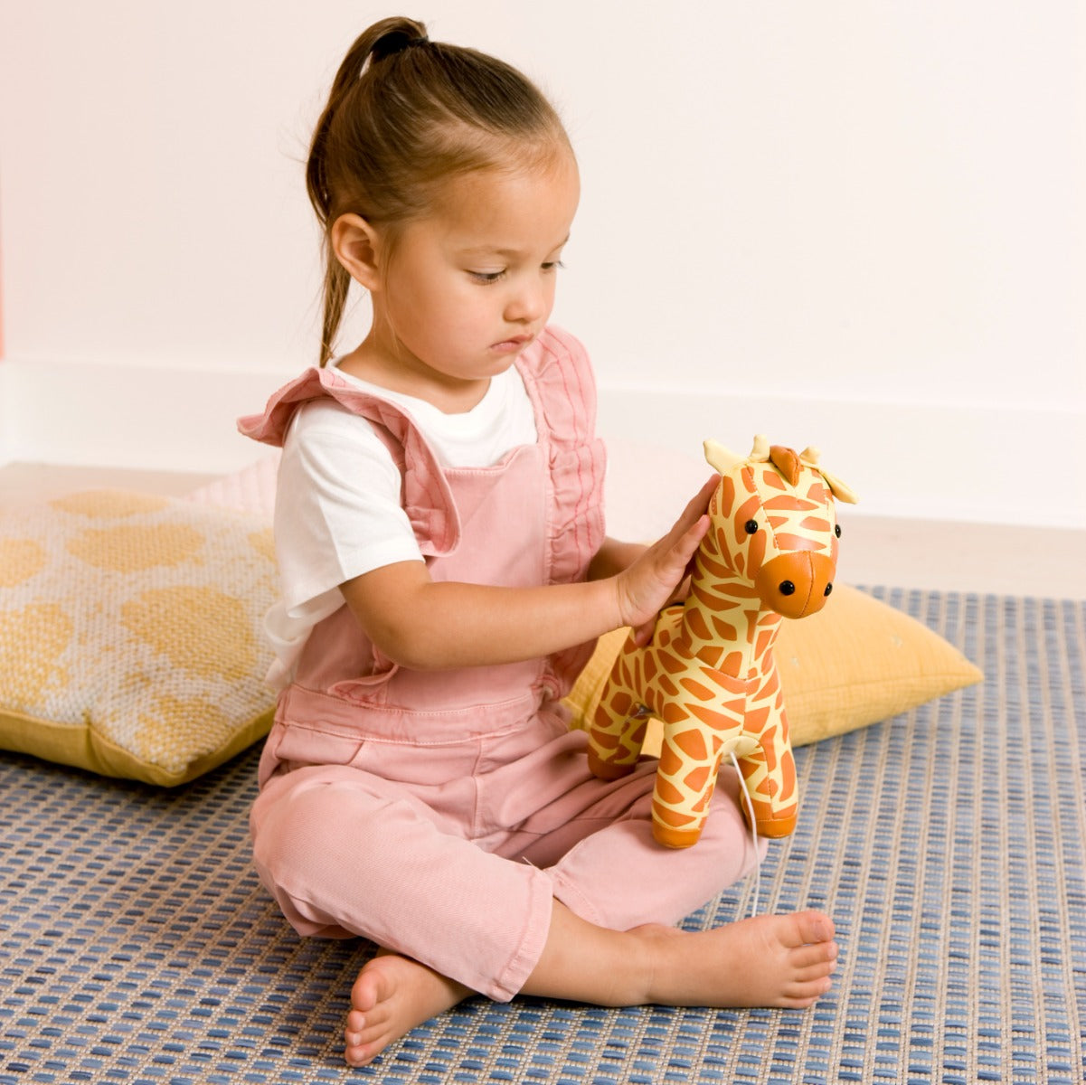 Little girl playing with Musical Friends - Gina the Giraffe from Little Big Friends
