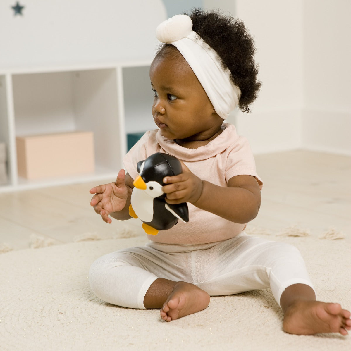 Little girl holding Little Big Friends tiny friends penguin