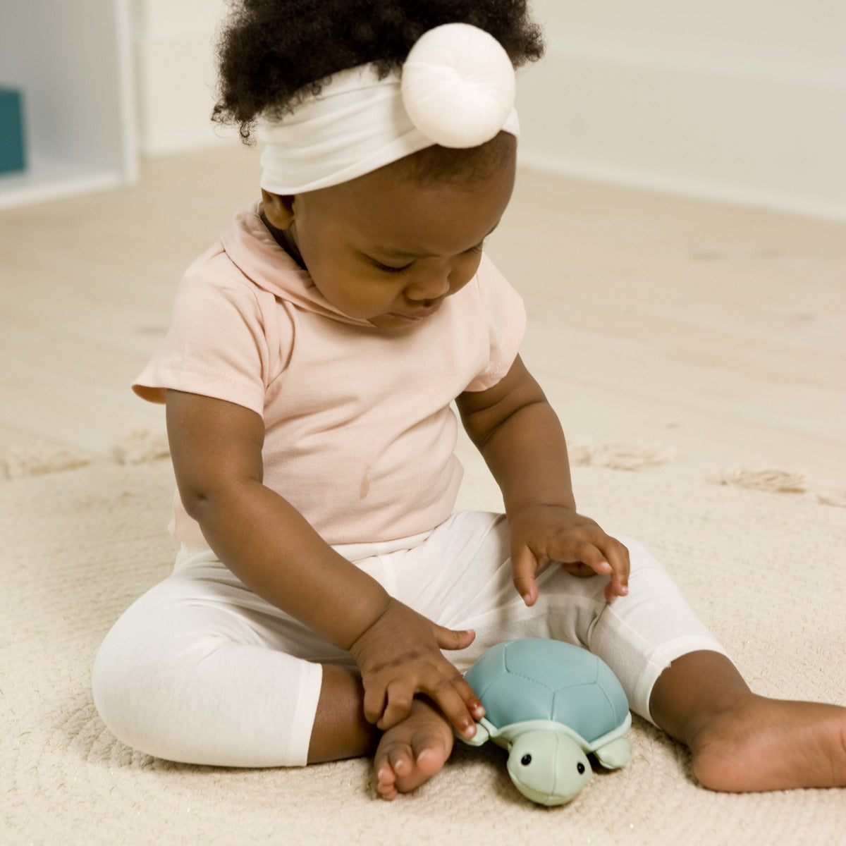Little girl playing with Little Big Friends, tiny friends Emilie the Turtle