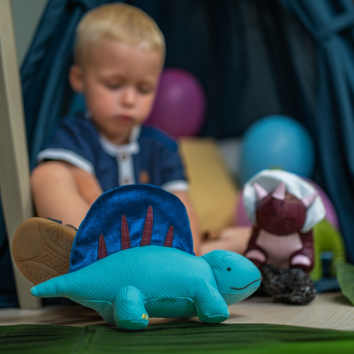 Boy playing with Little big friends Dimitri the Dimetrodon 