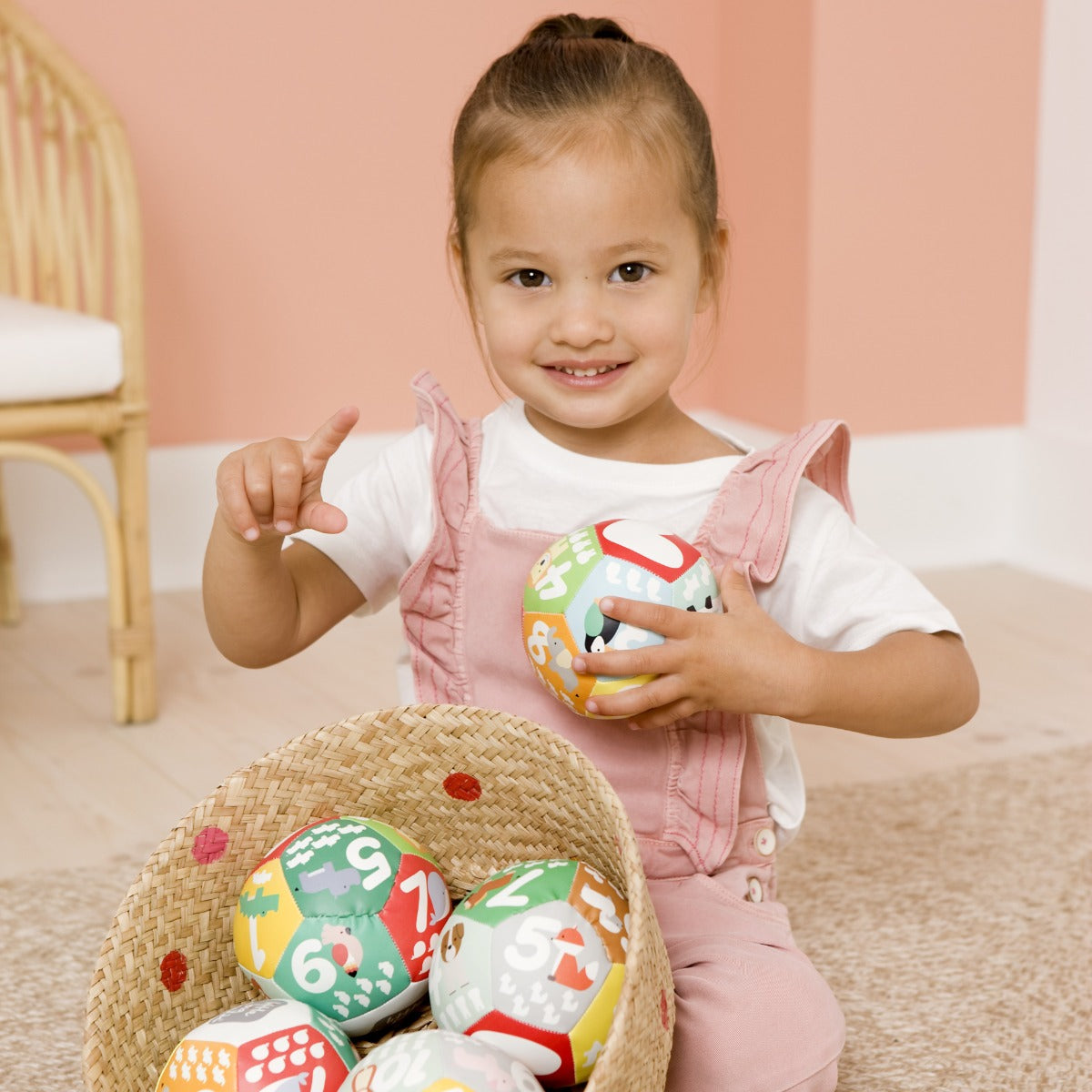 Toddler playing with Little big friends discovery soft ball for kids with numbers and animals
