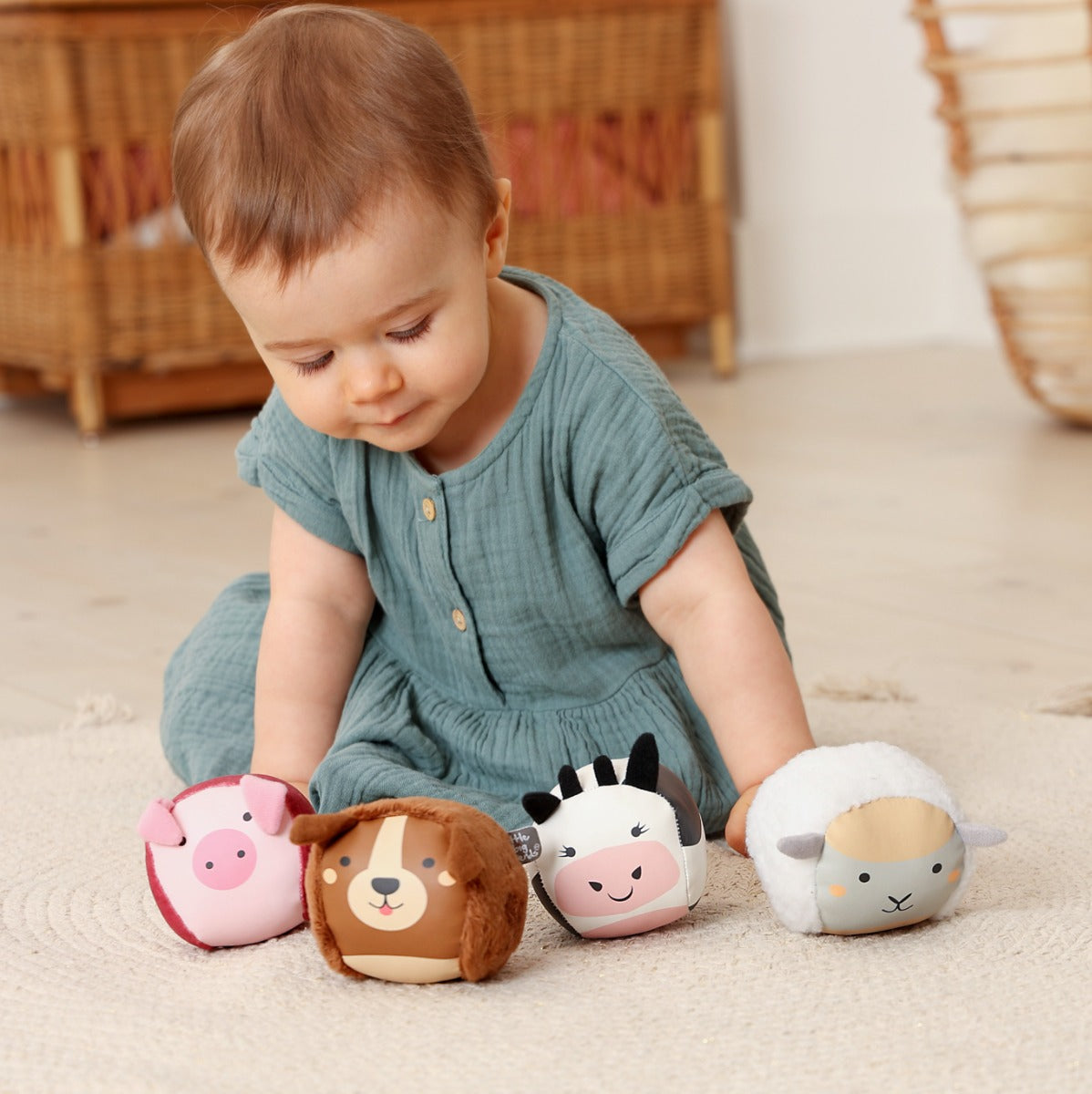 Little girl playing with Roly Poly farm animals soft balls