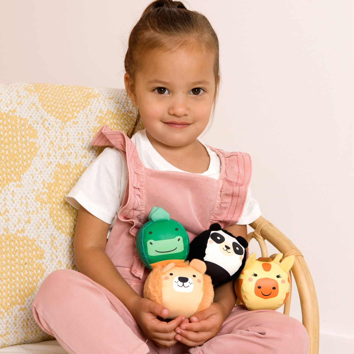 Toddler playing with Jungle animal theme Roly Poly plush balls for kids